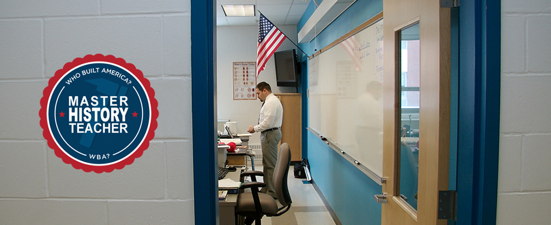 A picture of a classroom teacher with a badge