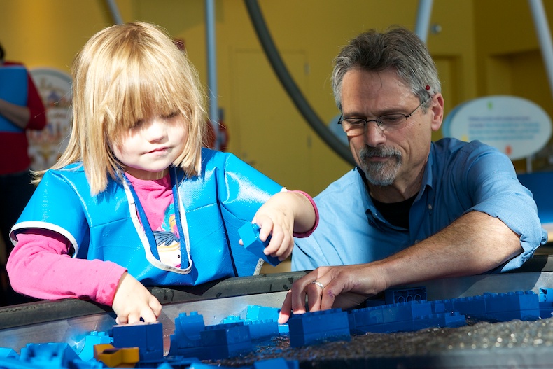 Early interest in science is a good predictor of a career in the field. Here, EDC’s Jeff Winokur helps a student use Legos to change the flow of water.
