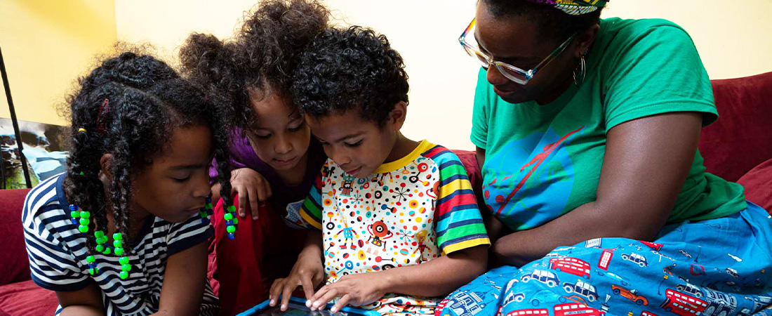 A photo of a family using a tablet
