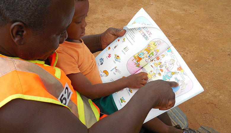 A photo of parent and child reading in Ghana