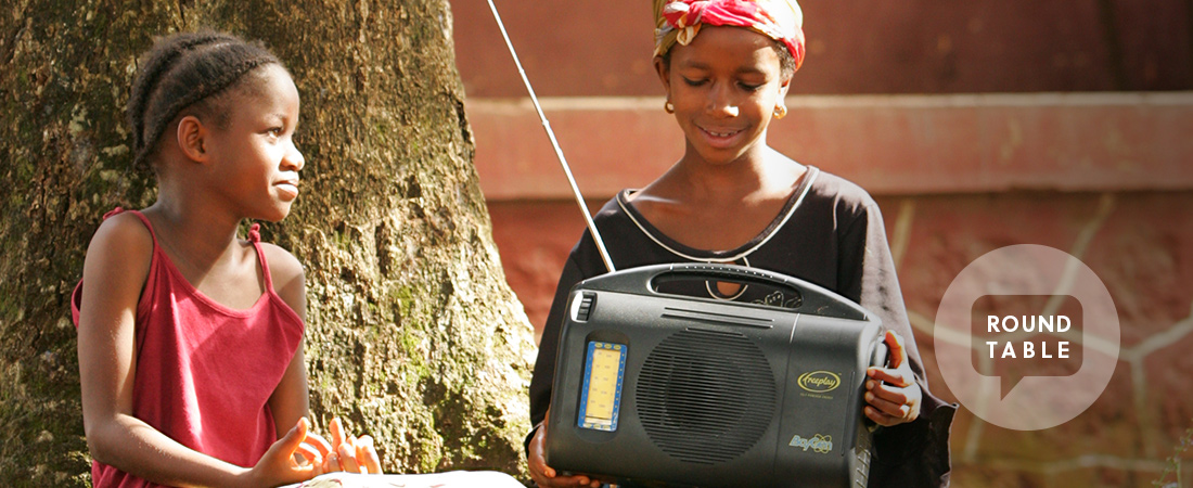 A photo of a teacher and student using a radio