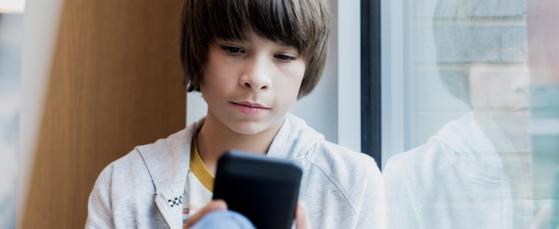 A teen using a phone representing Fighting Misinformation through Media Literacy