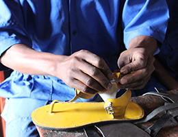 A photo of Christian Bayisenge shoemaking