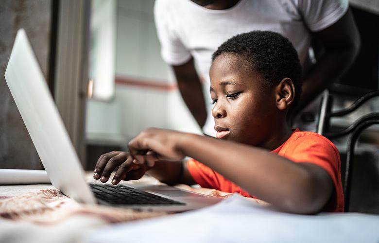 A photo of a child using a computer