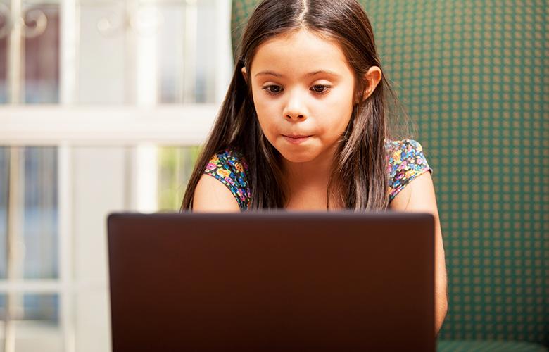 A photo of a child using a computer representing Resources for Schools and Districts Responding to the COVID-19 Crisis