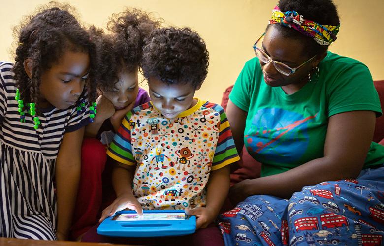 What the Tech? Can Tech Help Kids Make Sense of their World? A photo of parent and children using tablet
