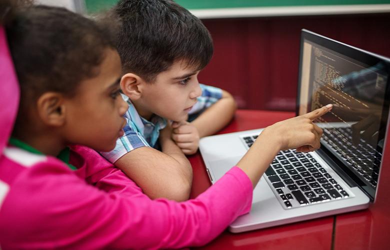 Celebrating Computer Science Education Week A photo of kids using a computer representing Celebrating Computer Science Education Week