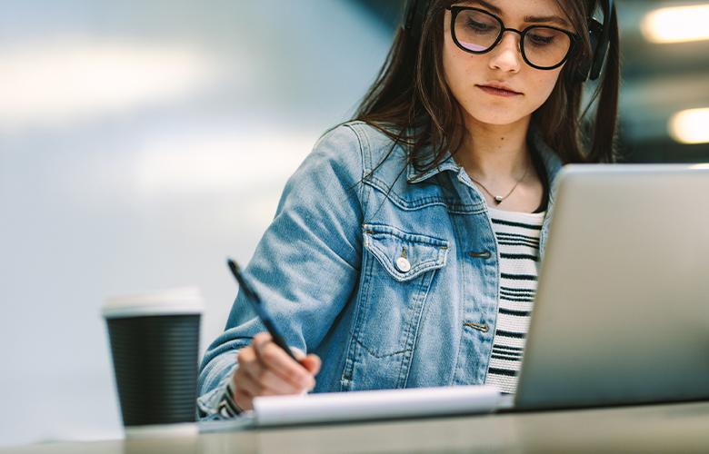 A photo of a person using a computer representing Making the Transition to Virtual Classrooms