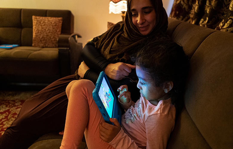 What the Tech?: Parenting, Young Children, and Digital Tools in the Age of COVID-19 A photo of parent and children using tablet