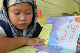 A child in the Philippines reading a book.
