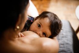 A  photo of a child breastfeeding 