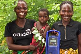 Remote Learning during COVID-19: EDC Interactive Audio Instruction Finds New Purpose A photo of parents and child with a radio