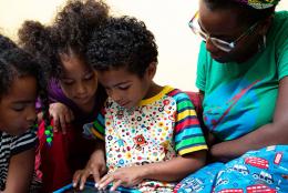 A photo of a family using a tablet