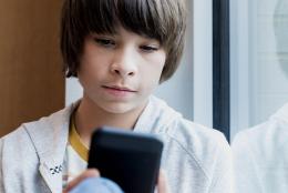 A teen using a phone representing Fighting Misinformation through Media Literacy