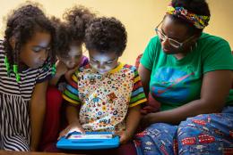What the Tech? Can Tech Help Kids Make Sense of their World? A photo of parent and children using tablet