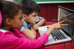 Celebrating Computer Science Education Week A photo of kids using a computer representing Celebrating Computer Science Education Week