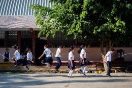 Children playing jump rope in a school yard