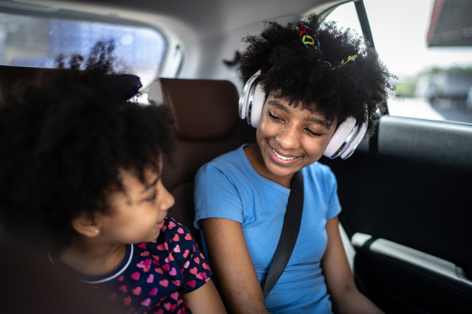 A photo of children listening to a podcast representing How Can Podcasts Support Family Learning? Findings from a New Report