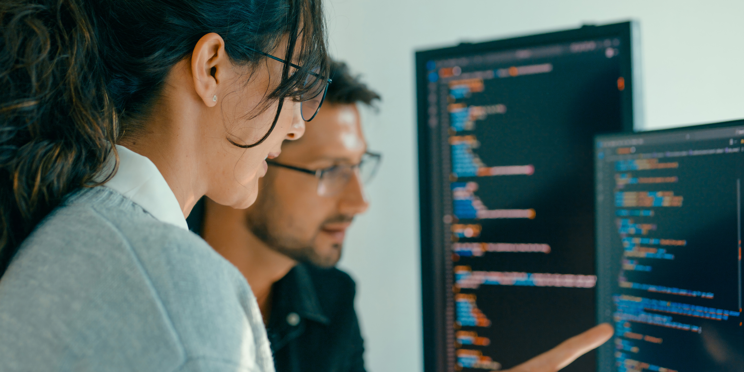 A photo of software developers representing What Will Software Developers Do When AI Learns to Code?