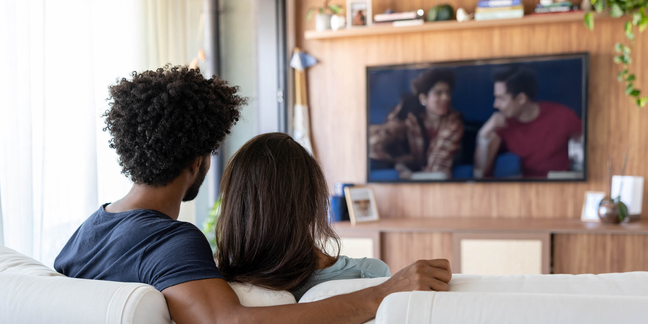 A photo of people watching TV representing Hollywood has the power to help transform suicide prevention