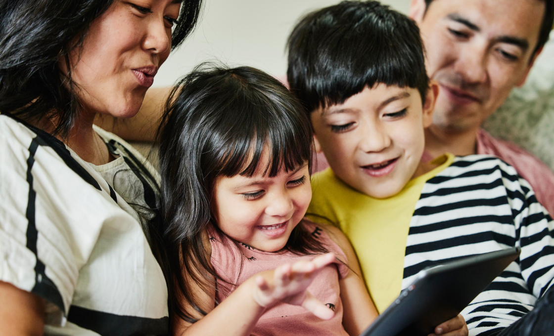A photo of a family using a tablet